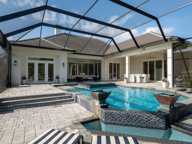 back of property with a patio, outdoor lounge area, stucco siding, a ceiling fan, and french doors