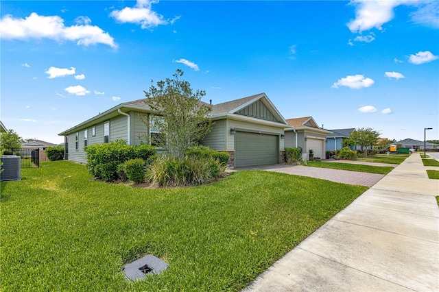 single story home featuring driveway, board and batten siding, central air condition unit, an attached garage, and a front lawn