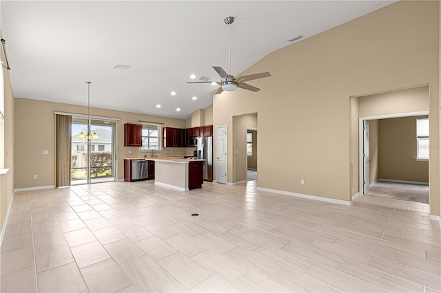 unfurnished living room featuring baseboards, high vaulted ceiling, visible vents, and ceiling fan with notable chandelier