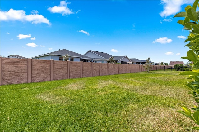 view of yard with fence and a residential view