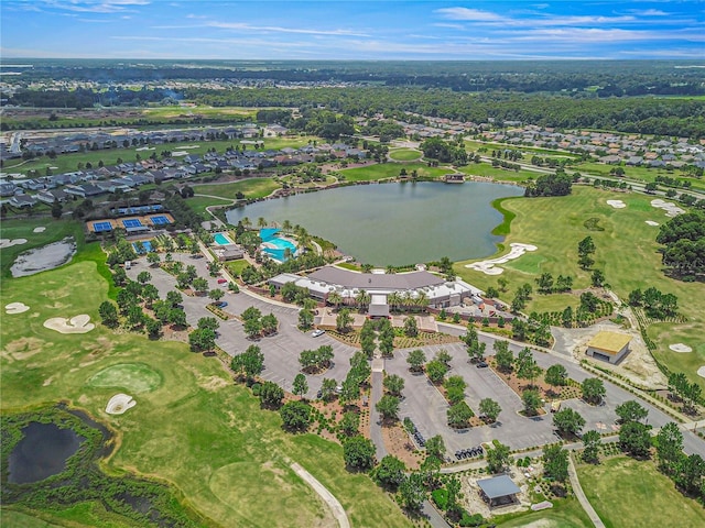 drone / aerial view with golf course view, a water view, and a residential view