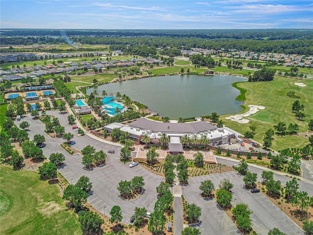aerial view with a residential view, a water view, and view of golf course