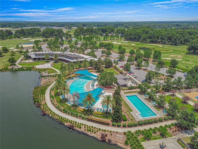 aerial view with golf course view and a water view