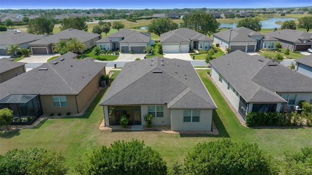 bird's eye view featuring a water view and a residential view