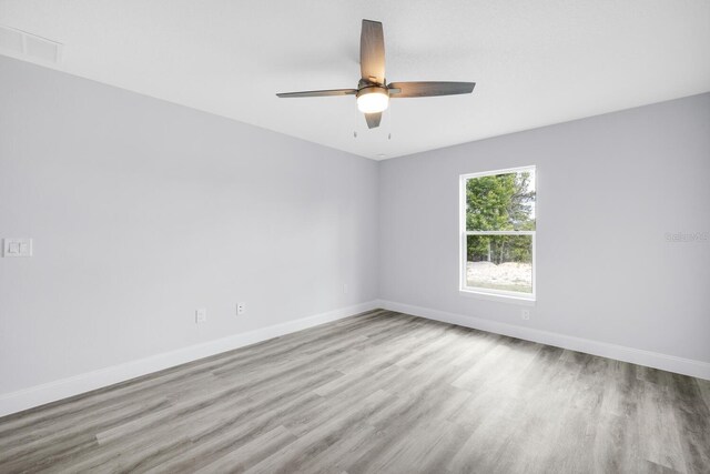 13493 SW 112th Pl, Dunnellon, FL 34432 - spare room featuring wood finished floors, baseboards, and ceiling fan