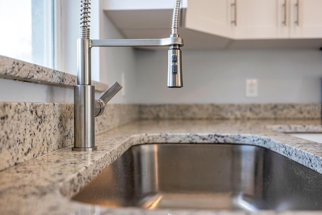 13493 SW 112th Pl, Dunnellon, FL 34432 - kitchen view of a sink, white cabinetry, and light stone counters
