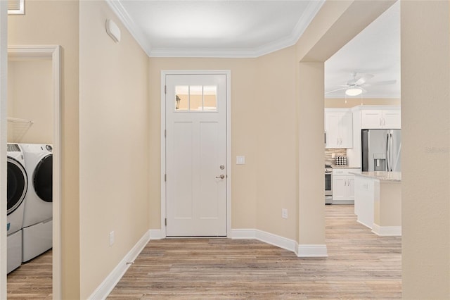 9923 SW 98th Ln, Ocala, FL 34481 - foyer entrance featuring light wood-type flooring, ornamental molding, and washing machine and clothes dryer