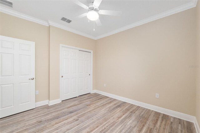 9923 SW 98th Ln, Ocala, FL 34481 - unfurnished bedroom featuring baseboards, visible vents, ornamental molding, and light wood-style flooring