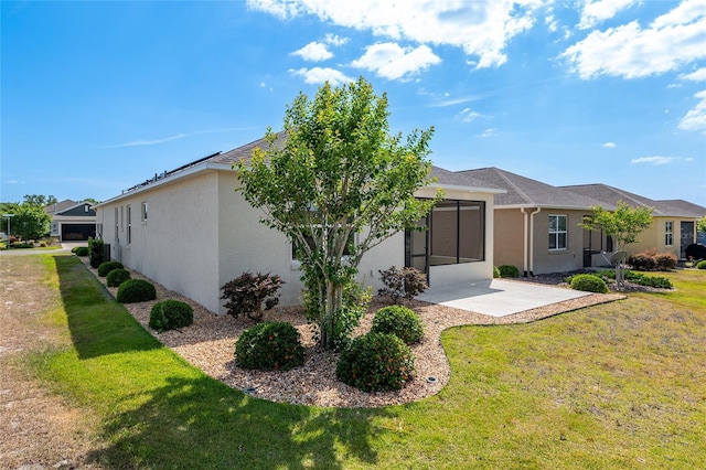 9923 SW 98th Ln, Ocala, FL 34481 - back of property with stucco siding, a yard, and a patio area
