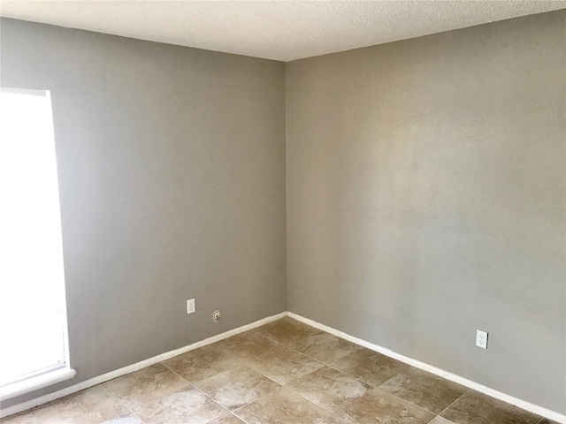 5440 SE 30th Pl, Ocala, FL 34480 - unfurnished room featuring baseboards and a textured ceiling