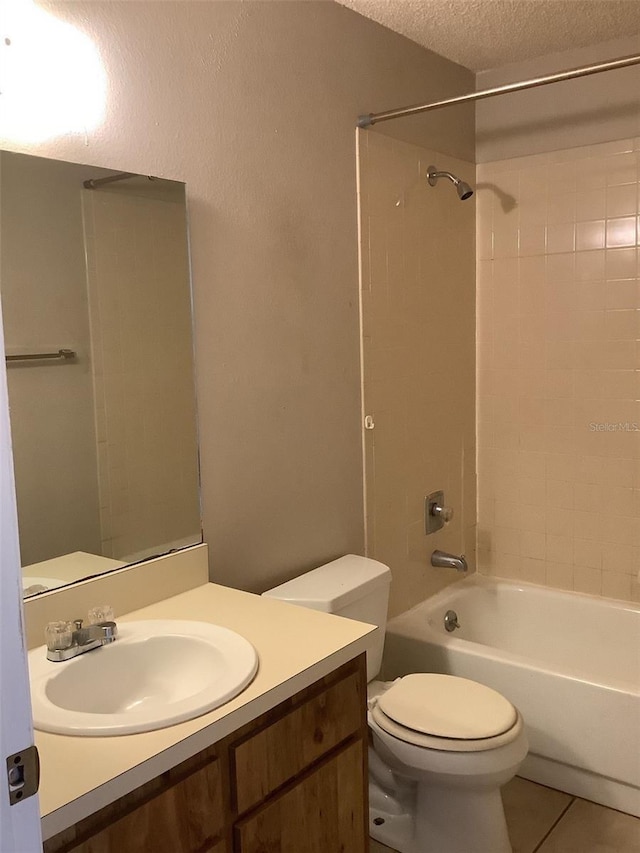 5440 SE 30th Pl, Ocala, FL 34480 - full bath with a textured ceiling, tile patterned flooring, vanity, toilet, and washtub / shower combination