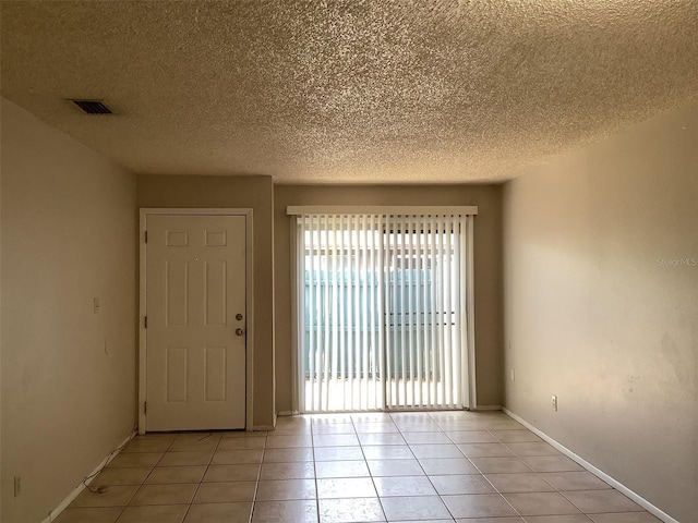 5440 SE 30th Pl, Ocala, FL 34480 - unfurnished room featuring light tile patterned floors, baseboards, a textured ceiling, and visible vents
