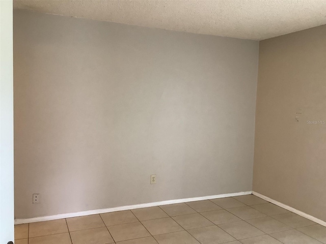 5440 SE 30th Pl, Ocala, FL 34480 - spare room with baseboards, a textured ceiling, and light tile patterned floors
