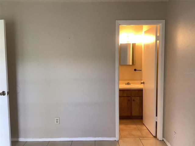 5440 SE 30th Pl, Ocala, FL 34480 - interior space featuring baseboards, a sink, ensuite bathroom, and light tile patterned floors