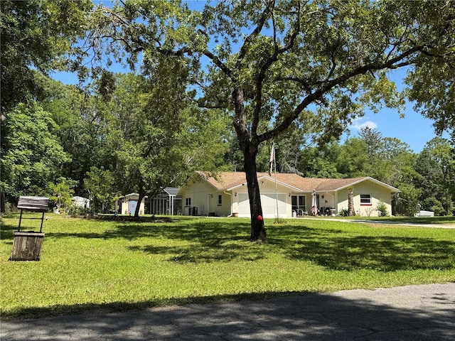 8951 SW 202nd Avenue Rd, Dunnellon, FL 34431 - view of front facade featuring an attached garage and a front yard