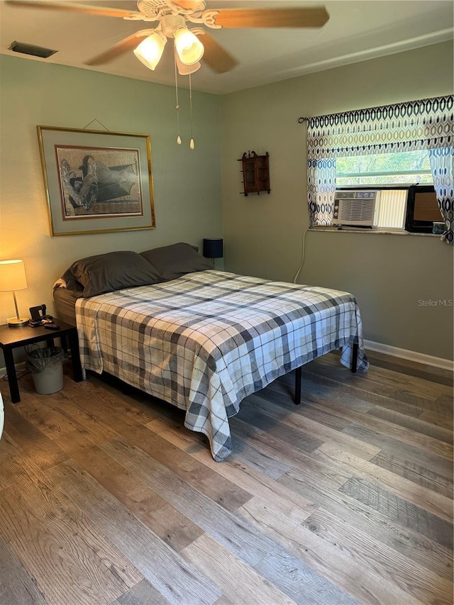 8951 SW 202nd Avenue Rd, Dunnellon, FL 34431 - bedroom with wood finished floors, baseboards, ceiling fan, and cooling unit