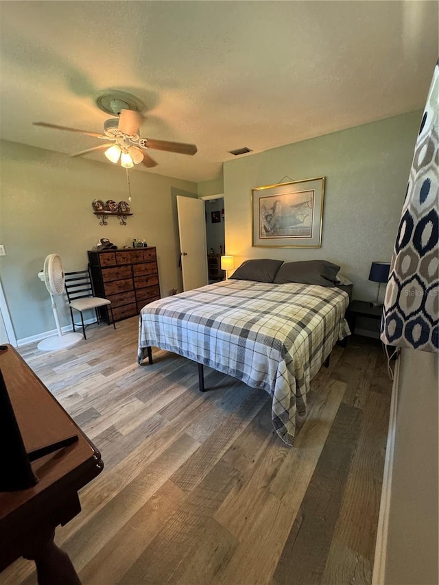 8951 SW 202nd Avenue Rd, Dunnellon, FL 34431 - bedroom featuring wood finished floors, a ceiling fan, and baseboards