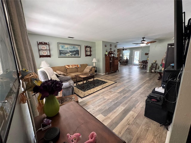 8951 SW 202nd Avenue Rd, Dunnellon, FL 34431 - living area featuring a ceiling fan, light wood-style flooring, and baseboards