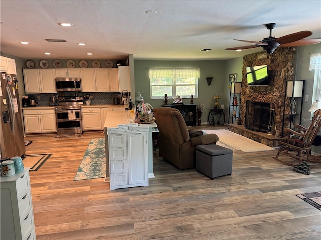 8951 SW 202nd Avenue Rd, Dunnellon, FL 34431 - living area with ceiling fan, light wood-style flooring, recessed lighting, and a fireplace