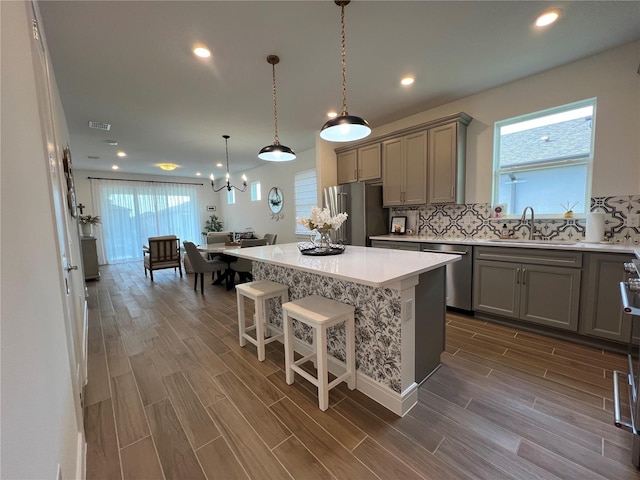 5785 SW 87th Court Rd, Ocala, FL 34481 - kitchen with appliances with stainless steel finishes, gray cabinetry, a sink, dark wood-style flooring, and recessed lighting