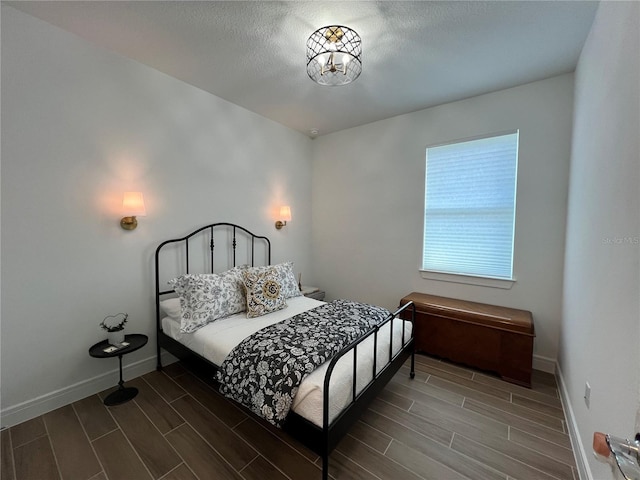 5785 SW 87th Court Rd, Ocala, FL 34481 - bedroom featuring wood finish floors, baseboards, and a textured ceiling