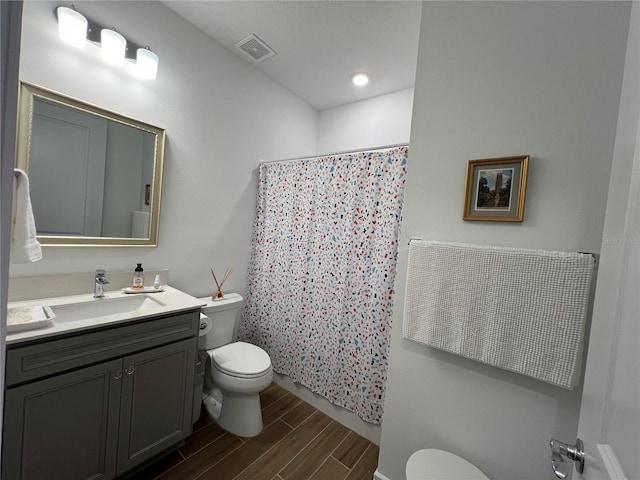 5785 SW 87th Court Rd, Ocala, FL 34481 - full bath with toilet, wood finish floors, vanity, and a shower with curtain