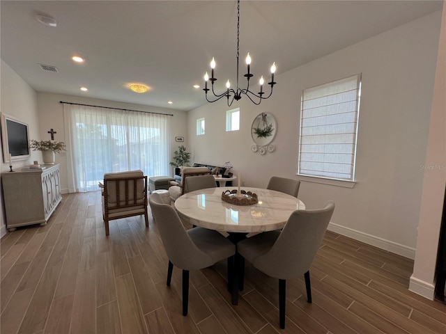 5785 SW 87th Court Rd, Ocala, FL 34481 - dining space with dark wood finished floors, a chandelier, baseboards, and recessed lighting