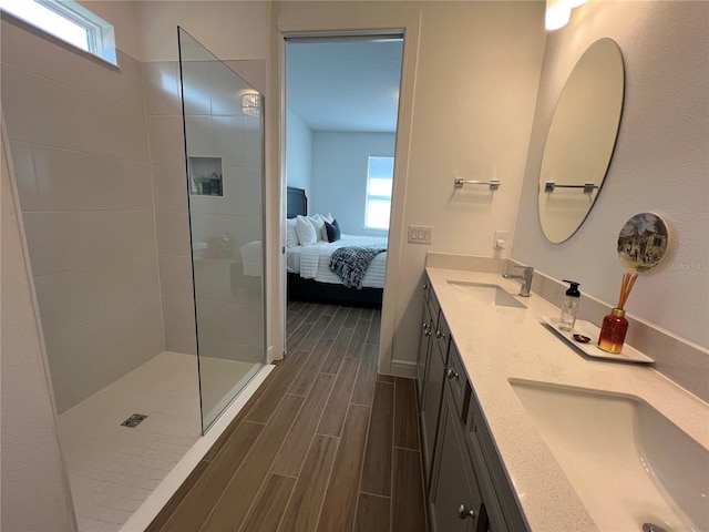 5785 SW 87th Court Rd, Ocala, FL 34481 - full bathroom featuring wood finish floors, connected bathroom, a walk in shower, double vanity, and baseboards