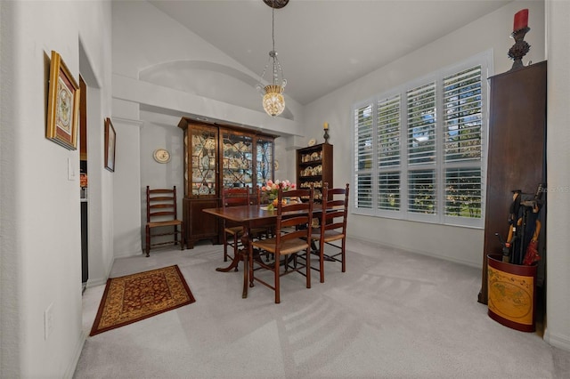 811 SE 49th Ave, Ocala, FL 34471 - dining room featuring carpet flooring, vaulted ceiling, and an inviting chandelier