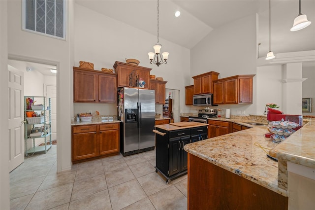 811 SE 49th Ave, Ocala, FL 34471 - kitchen featuring light tile patterned flooring, light stone countertops, high vaulted ceiling, stainless steel appliances, and visible vents