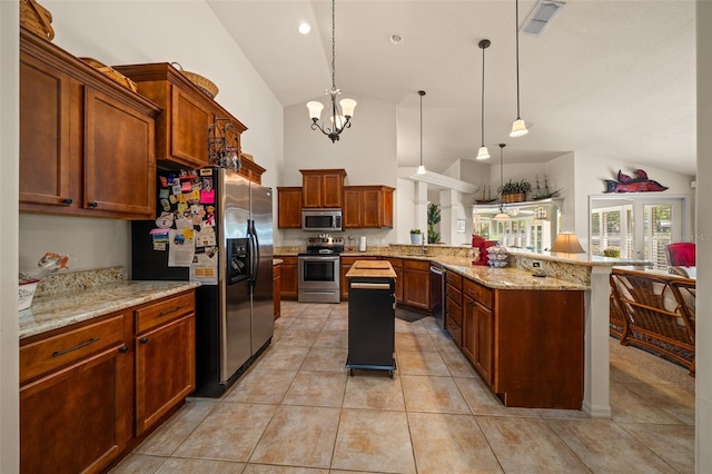 811 SE 49th Ave, Ocala, FL 34471 - kitchen with a peninsula, light stone countertops, high vaulted ceiling, appliances with stainless steel finishes, and light tile patterned floors