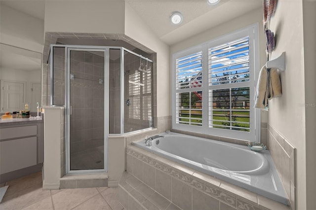 811 SE 49th Ave, Ocala, FL 34471 - full bathroom featuring vanity, tile patterned floors, a shower stall, and a garden tub