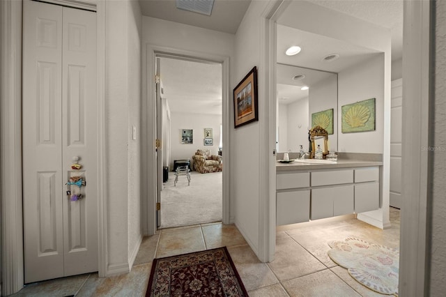 811 SE 49th Ave, Ocala, FL 34471 - hall featuring a sink, light carpet, light tile patterned flooring, and visible vents