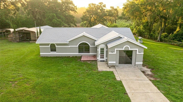 14171 SW 8th Ave, Ocala, FL 34473 - ranch-style home featuring a shingled roof, a front yard, and stucco siding