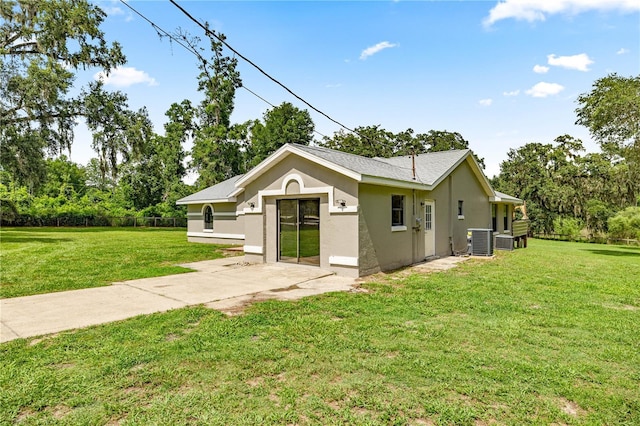 14171 SW 8th Ave, Ocala, FL 34473 - view of side of home with stucco siding, a lawn, and view of scattered trees