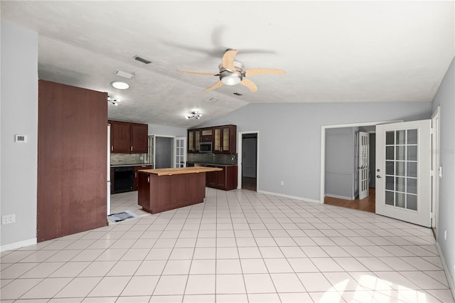14171 SW 8th Ave, Ocala, FL 34473 - kitchen featuring stainless steel microwave, vaulted ceiling, a center island, decorative backsplash, and ceiling fan