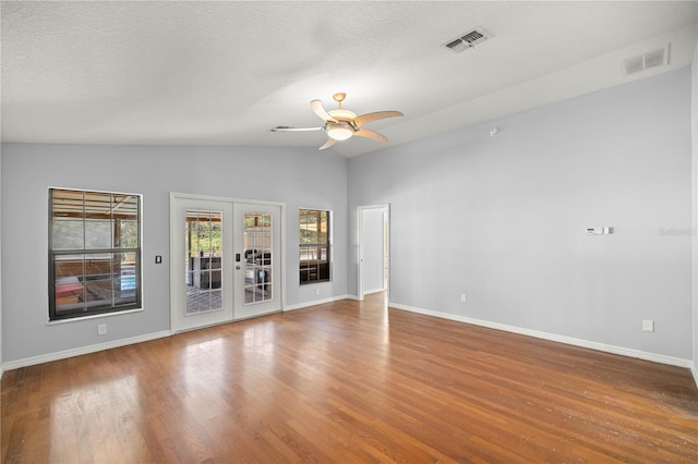 14171 SW 8th Ave, Ocala, FL 34473 - unfurnished room featuring lofted ceiling, french doors, a ceiling fan, wood finished floors, and a textured ceiling
