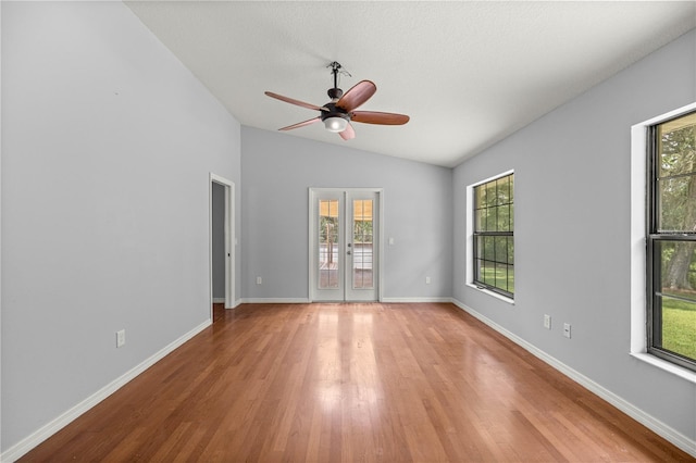 14171 SW 8th Ave, Ocala, FL 34473 - empty room with light wood-style flooring, vaulted ceiling, plenty of natural light, ceiling fan, and french doors