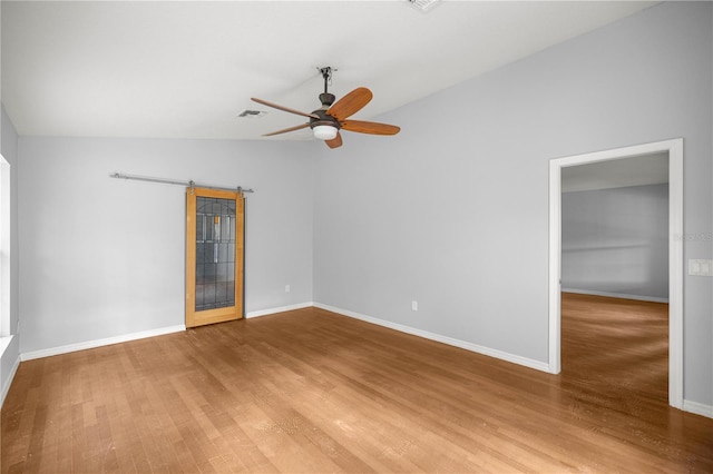 14171 SW 8th Ave, Ocala, FL 34473 - empty room with wood finished floors, a ceiling fan, a barn door, and lofted ceiling