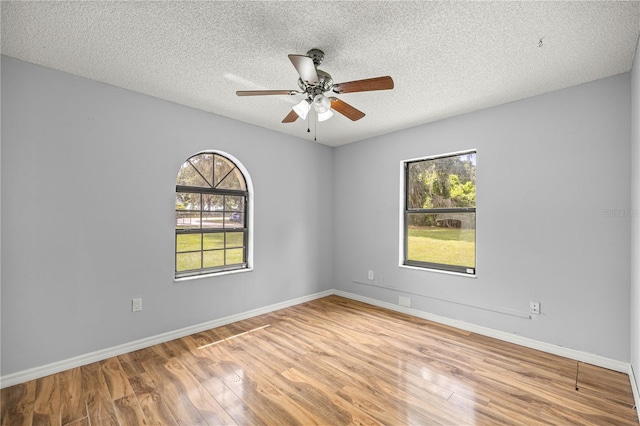 14171 SW 8th Ave, Ocala, FL 34473 - spare room featuring wood finished floors, a ceiling fan, and a textured ceiling