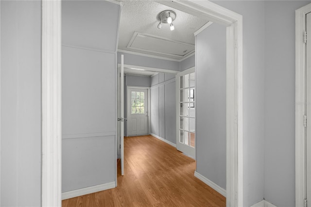 14171 SW 8th Ave, Ocala, FL 34473 - hall with attic access, wood finished floors, and a textured ceiling