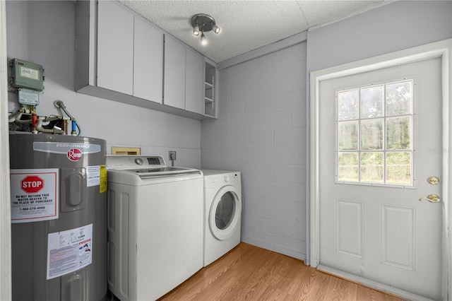14171 SW 8th Ave, Ocala, FL 34473 - laundry room with water heater, cabinet space, independent washer and dryer, concrete block wall, and light wood-type flooring