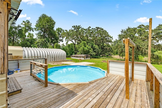 14171 SW 8th Ave, Ocala, FL 34473 - swimming pool featuring a wooden deck, view of scattered trees, and a lawn