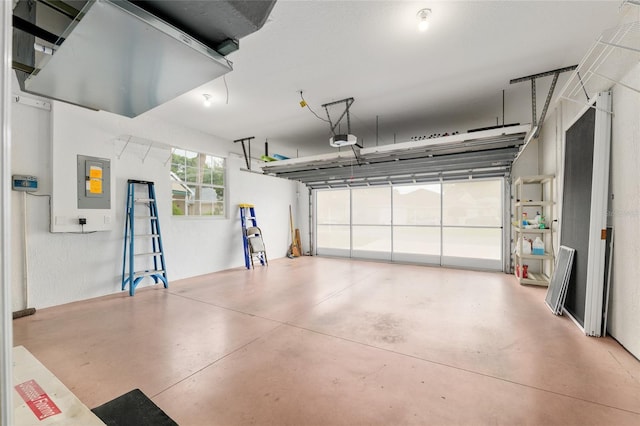 garage with a garage door opener and electric panel
