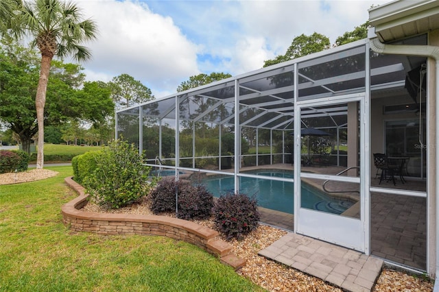 outdoor pool featuring a lanai, a patio area, and a lawn