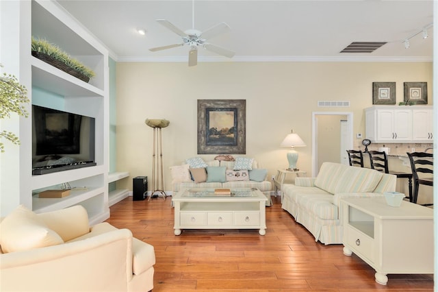 living area featuring visible vents, ornamental molding, a ceiling fan, and rail lighting