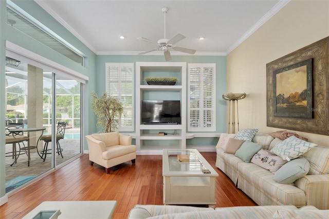 living room with recessed lighting, built in features, crown molding, a ceiling fan, and hardwood / wood-style floors