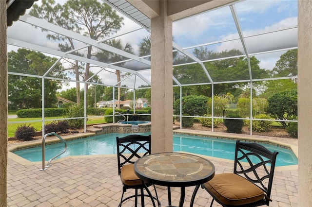 pool featuring a patio and an in ground hot tub