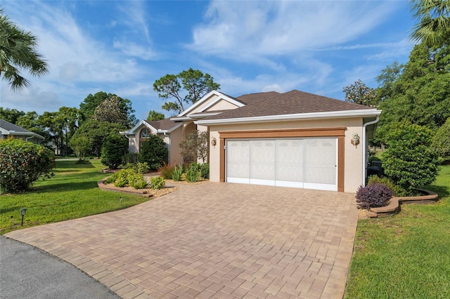 single story home with stucco siding, decorative driveway, an attached garage, and a front lawn