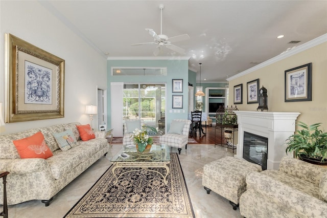 living area featuring visible vents, a ceiling fan, and crown molding